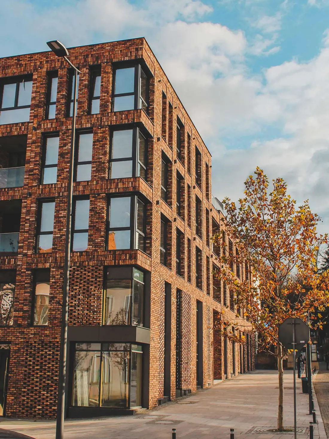 Brick apartment building with rows of large windows
