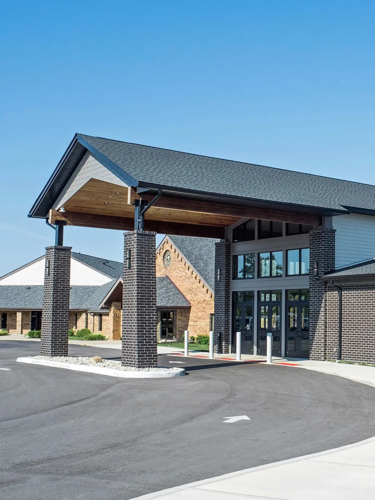 Church entrance with a covered drop-off and glass doors