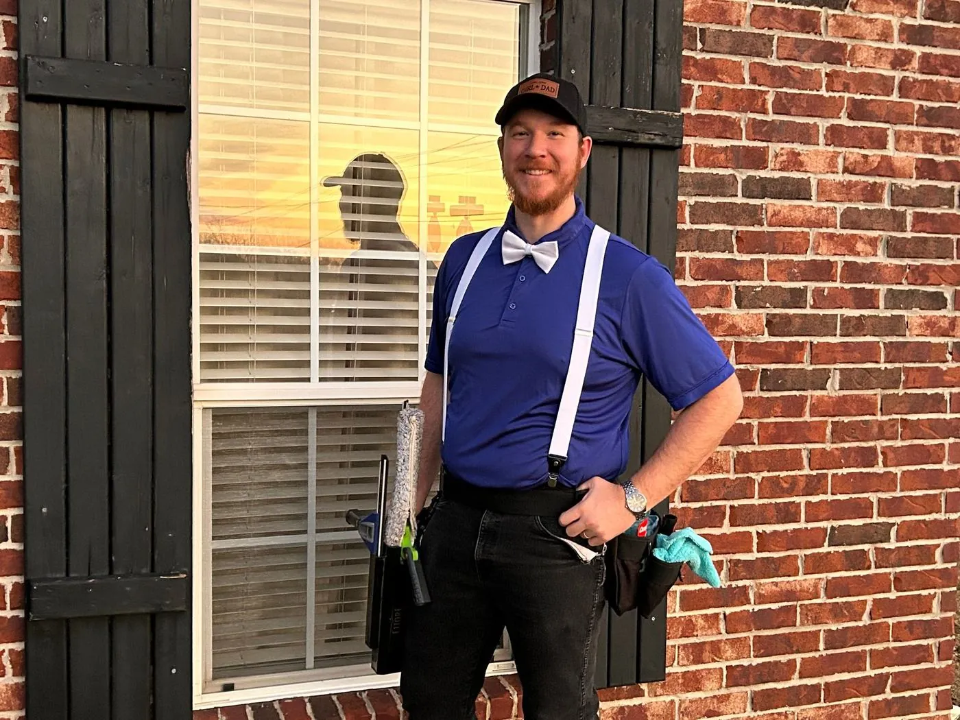 Jacob Tarter, founder of ClearSight, standing beside a window with his cleaning tools